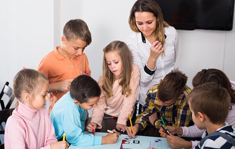 teacher teaching small children in classroom